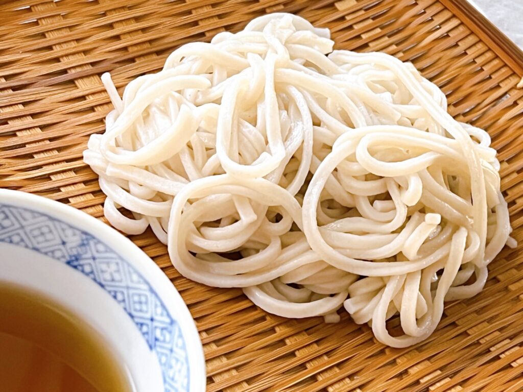 ざるの上に盛られたうどんの麺