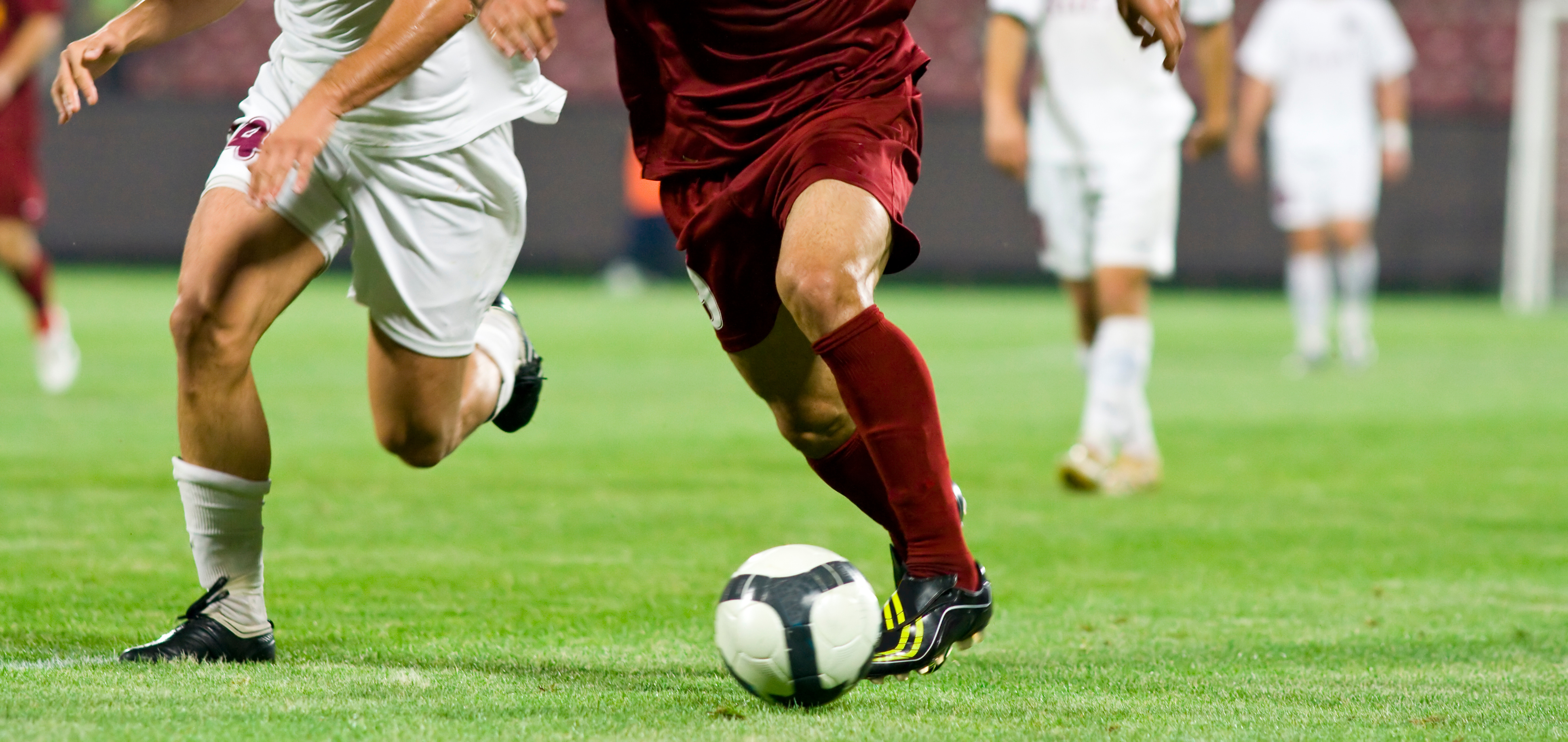 Soccer players competing for the ball, illustrating new US media rights deals for live sport