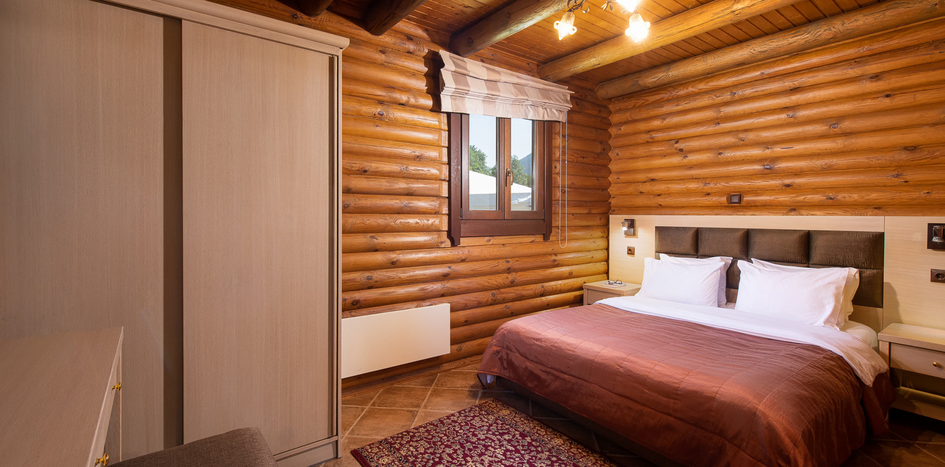 Bed, nightstands and closet in Natura Chalet bedroom