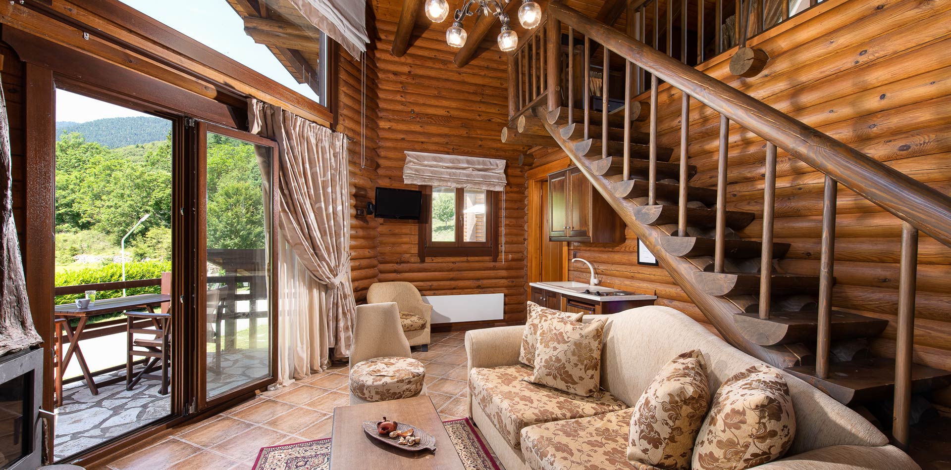 Living room with a staircase in Natura Chalets