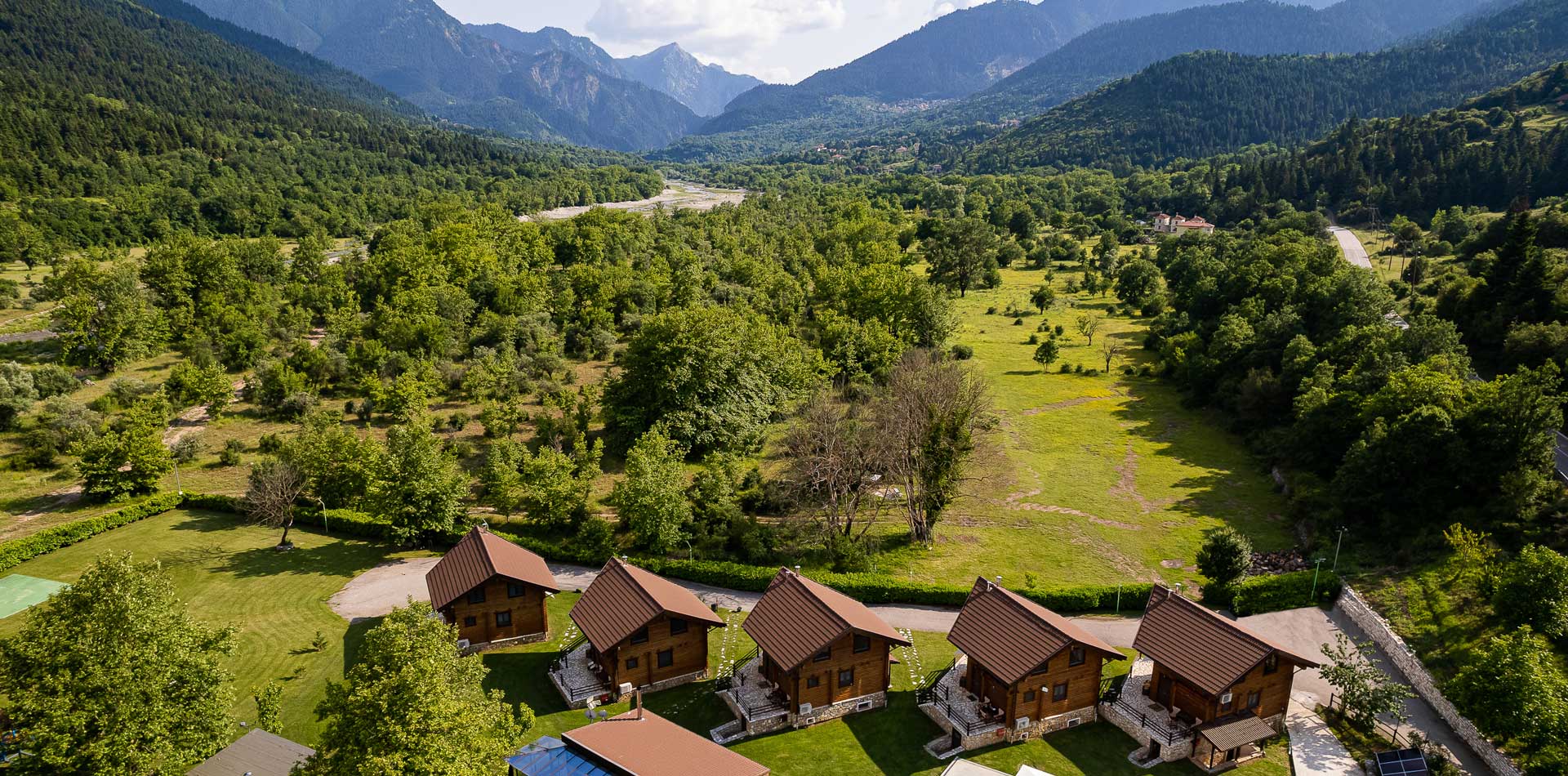 Panoramic view of Natura Chalets with mountains in the background