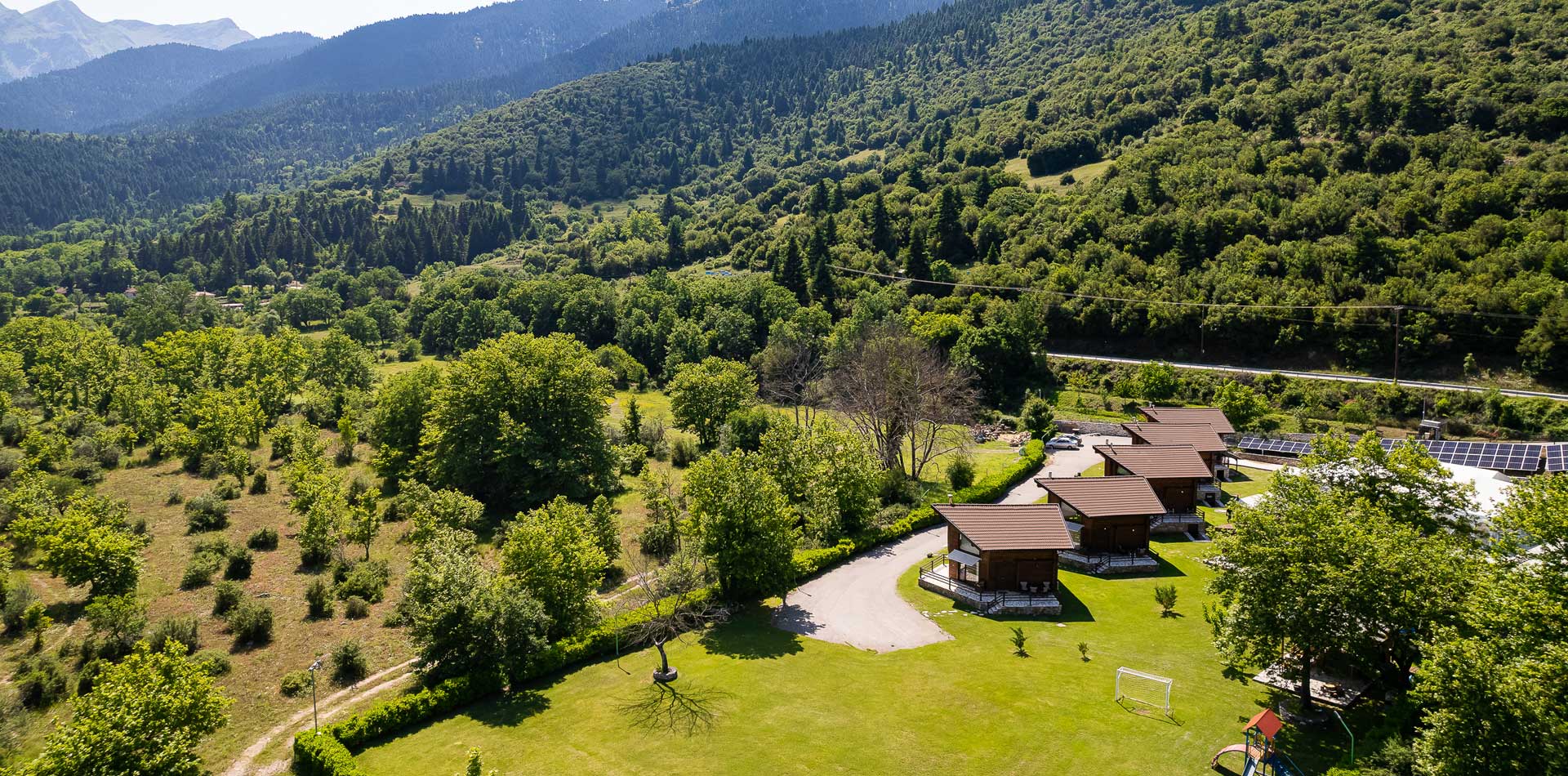 Panoramic view of Natura Chalets with mountains in the background