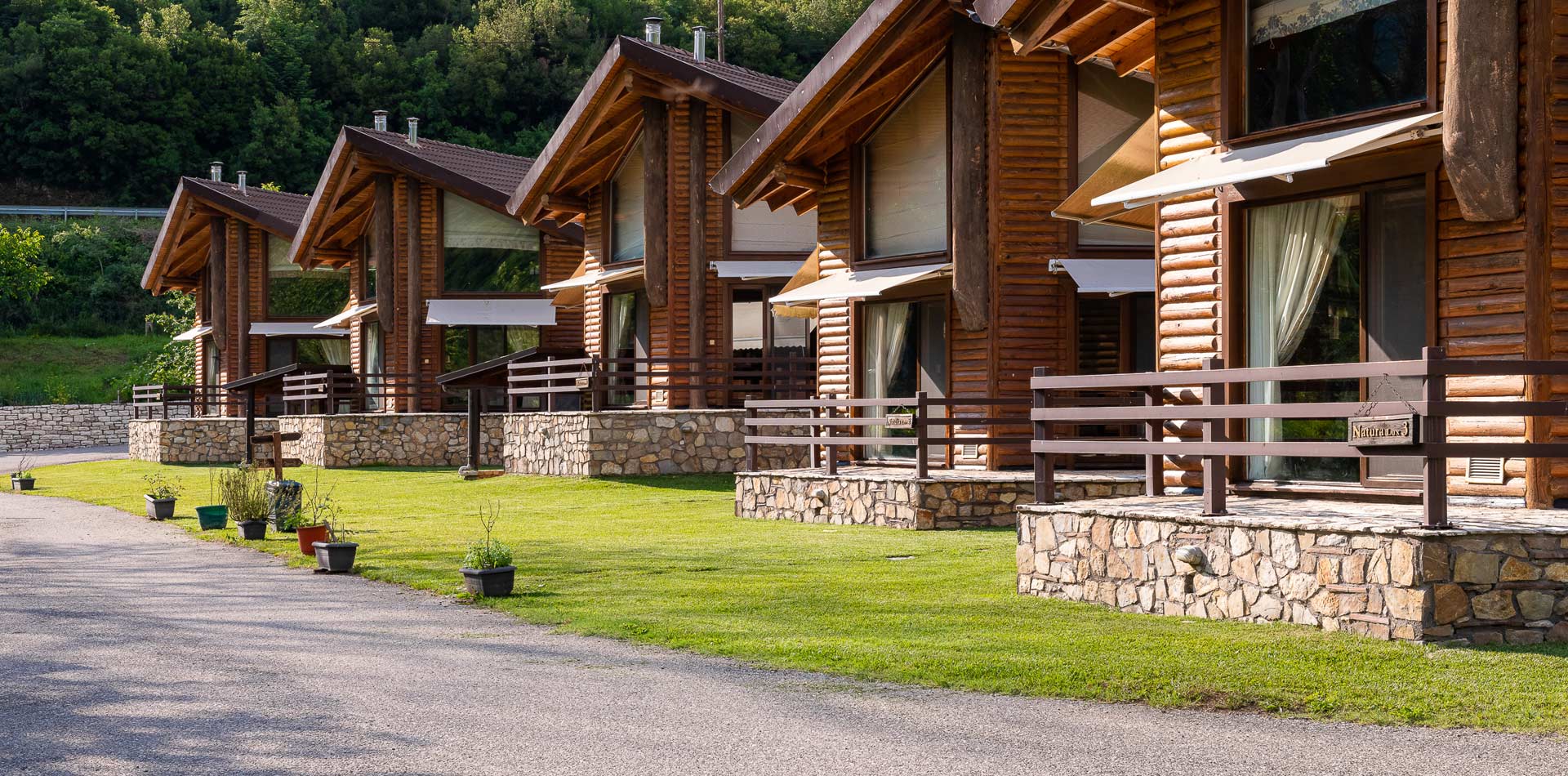 Row of log cabins in the woods.