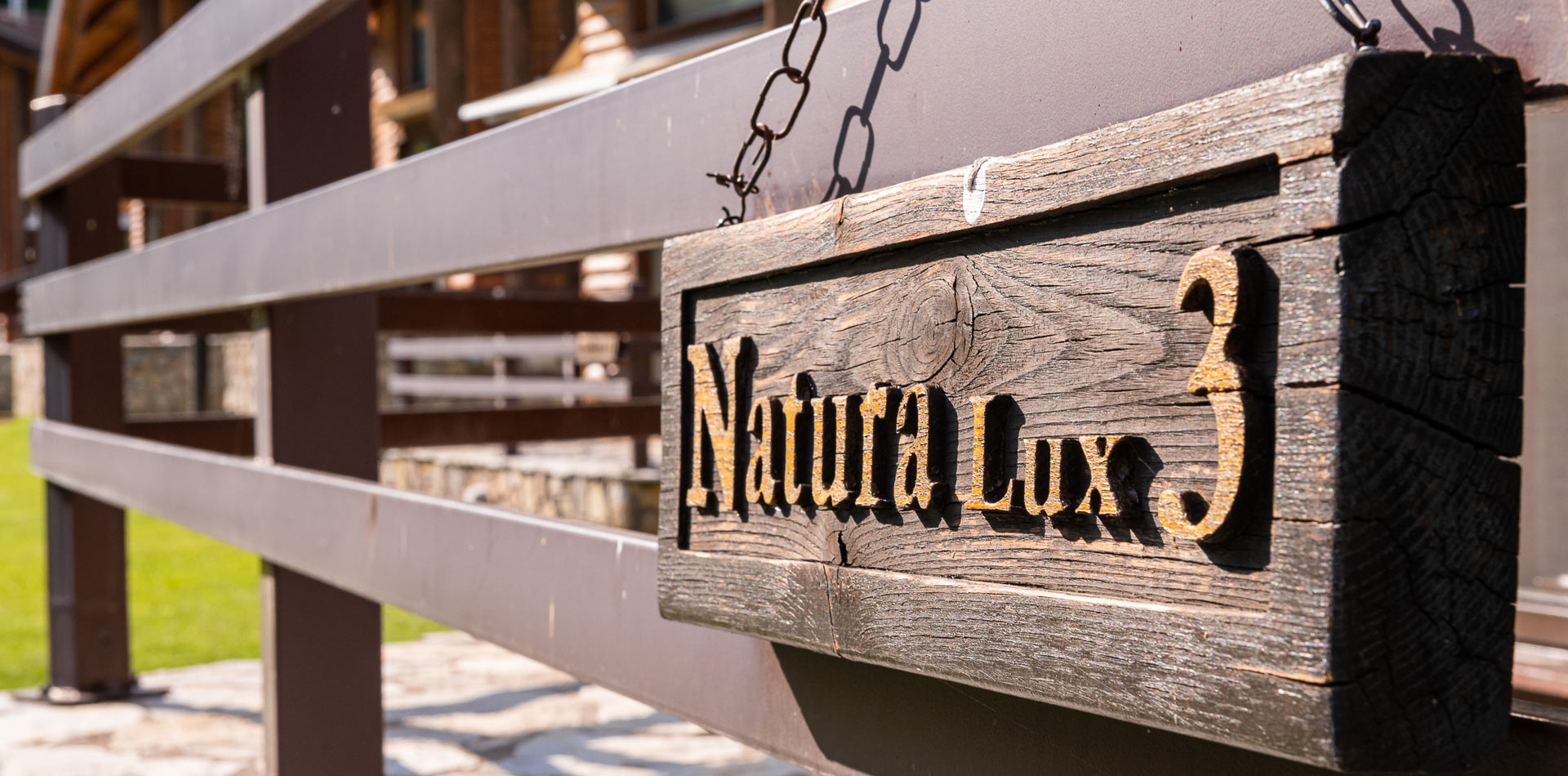 Wooden chairs and table at Natura Chalet's balcony