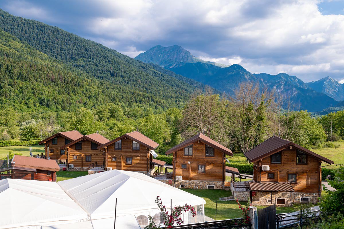 Aerial view of Natura Chalets with mountains in the background