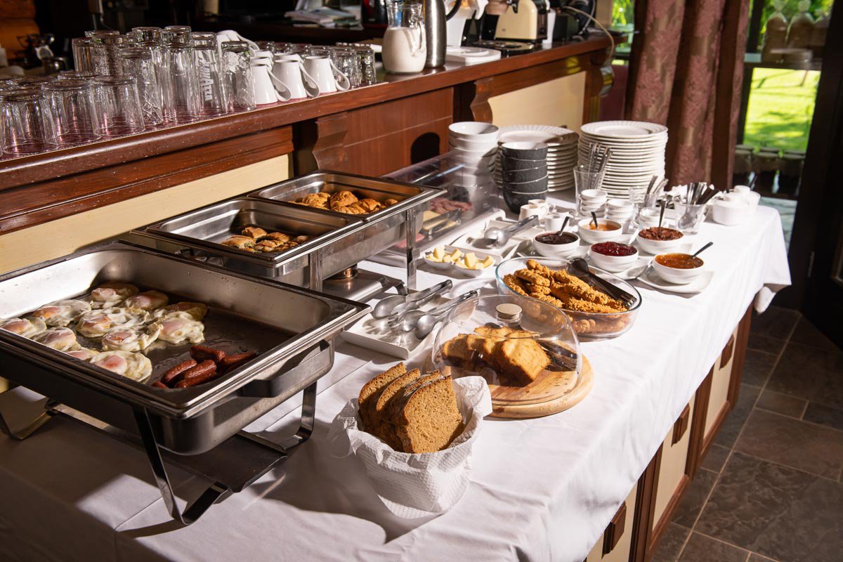 Buffet table with pastries, breads, fruits, and vegetables