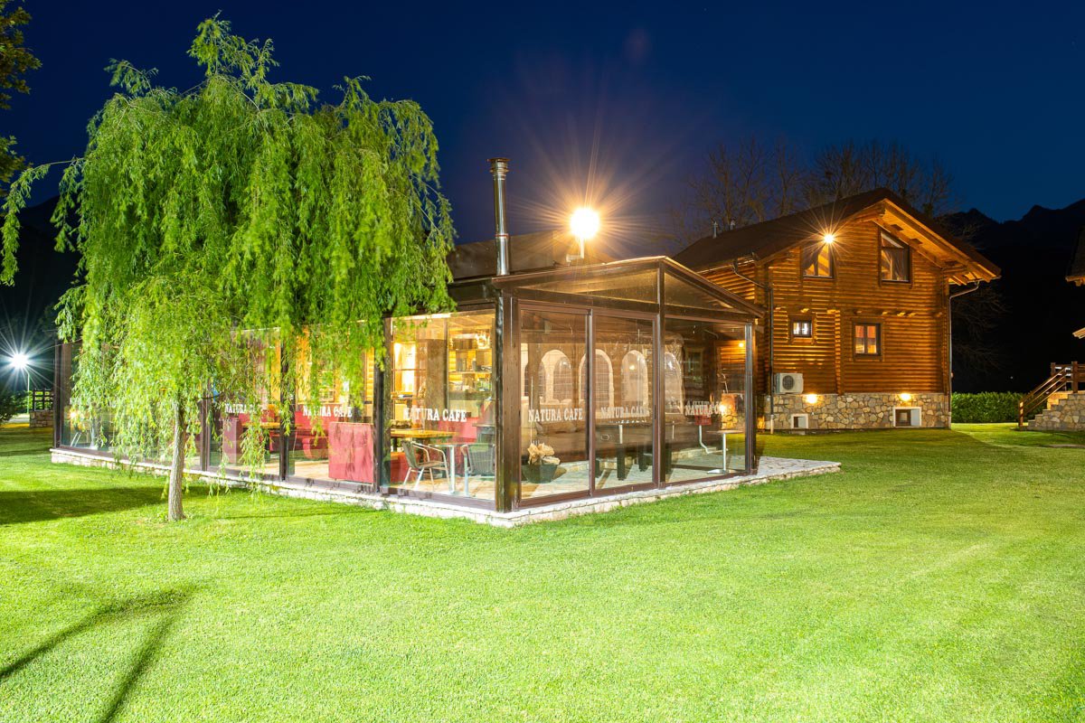 Natura Chalet outdoor area at night