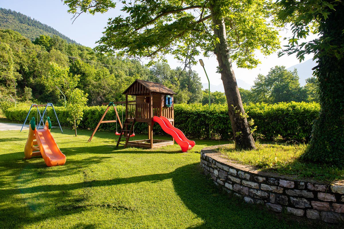 Playground with slide, swings, and treehouse