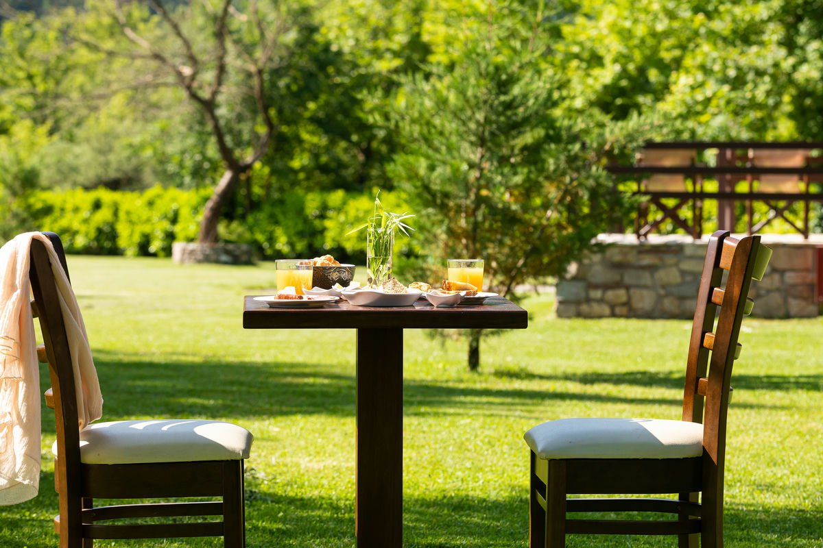 Couple of chairs and a table at Natura Chalet's outdoor area