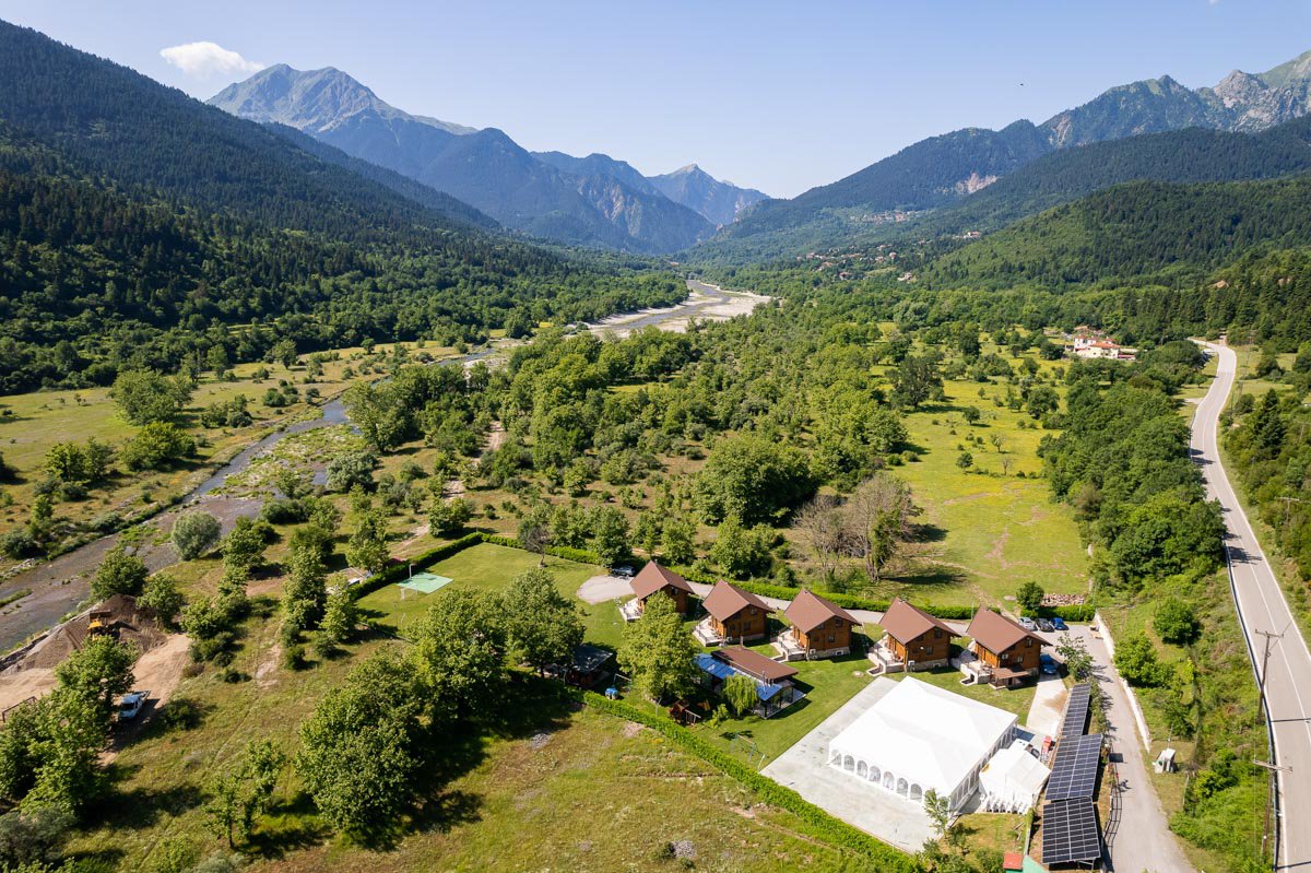 Aerial view of Natura Chalets with mountains in the background