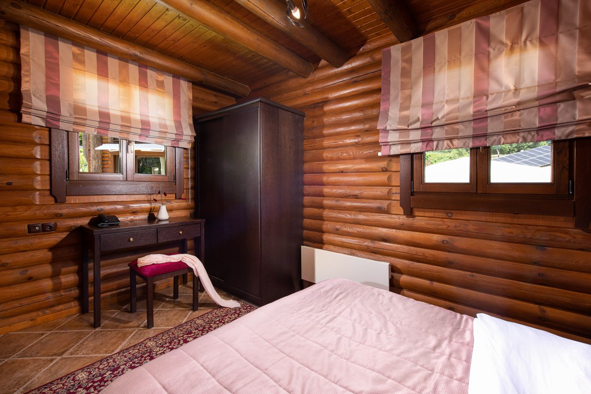 Desk, closet and windows in Natura Chalet Lux's bedroom