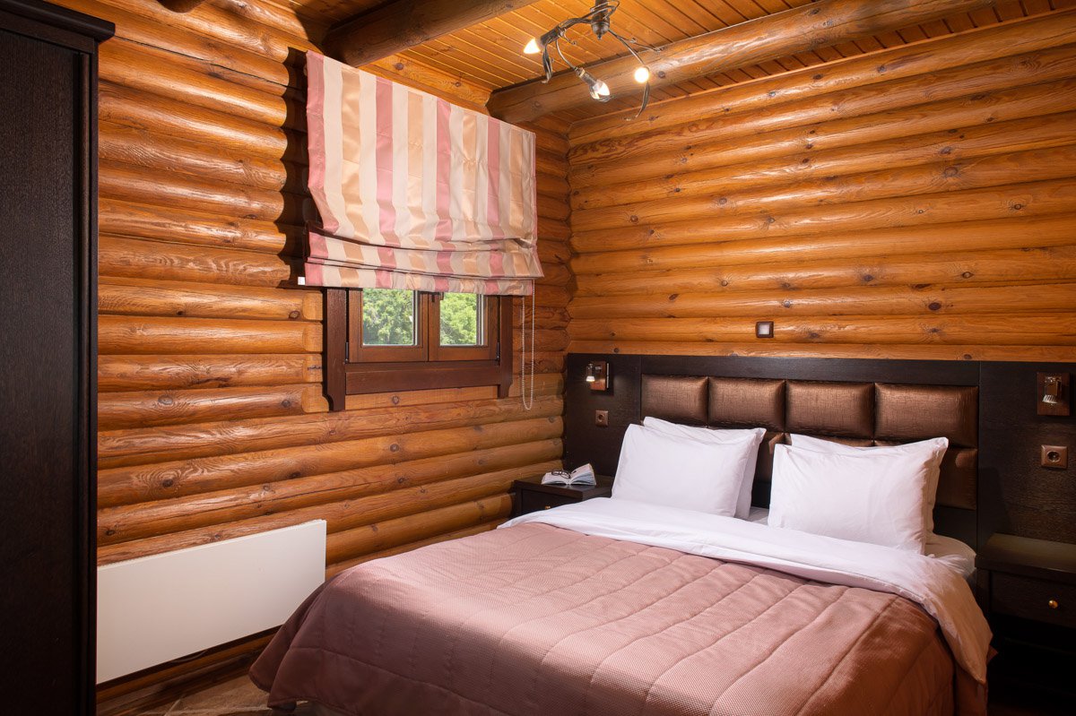 Bed with window at Natura Chalet Lux