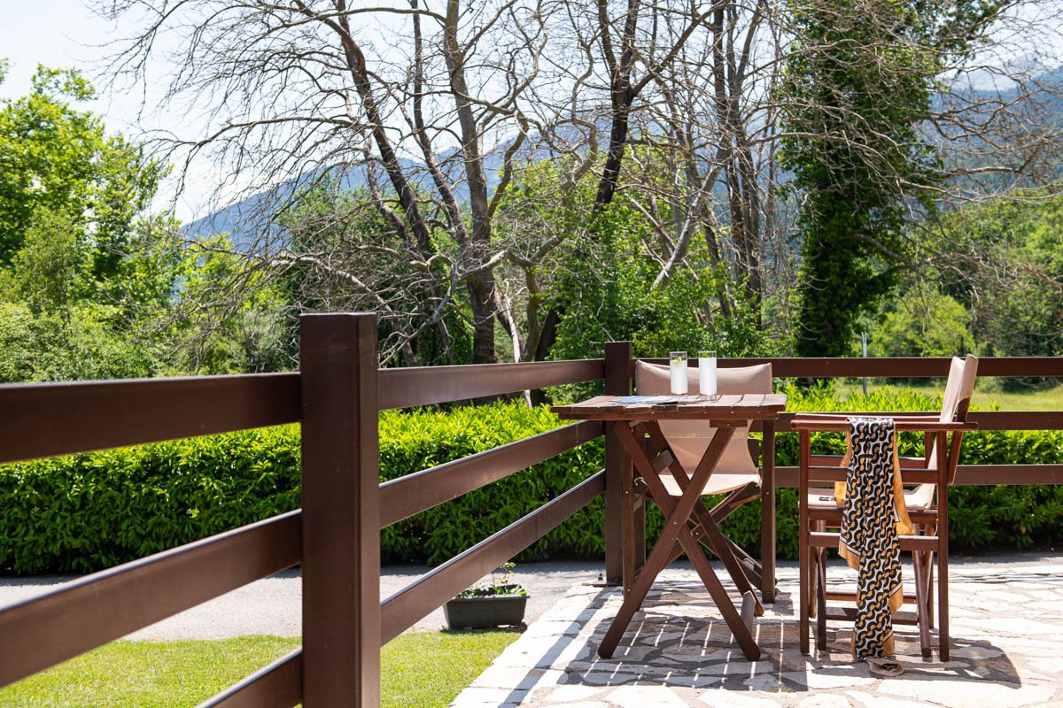 Natura chalet balcony with wooden chairs and tables