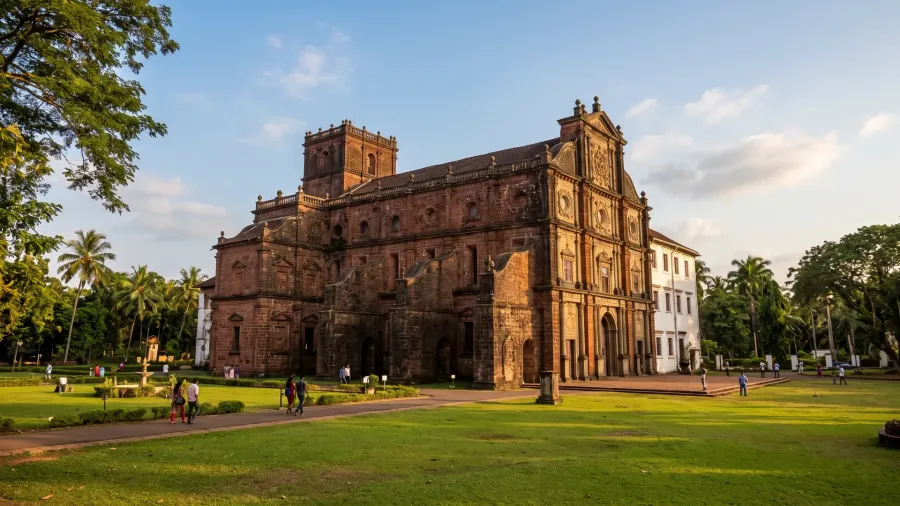 Basilica of Bom Jesus in Old Goa with its red laterite facade and green lawn
