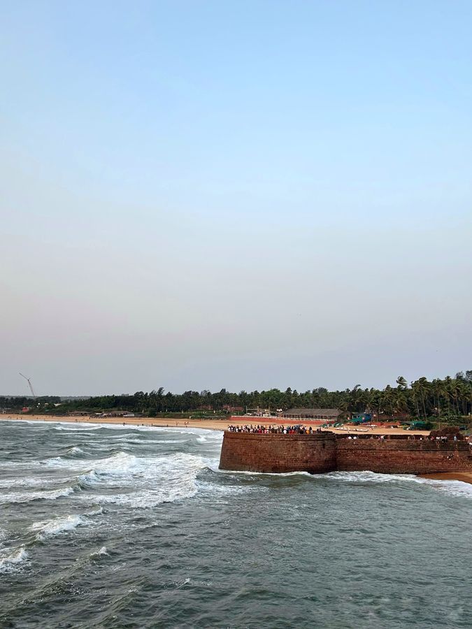 Coastal fort and sea at sunset in Goa