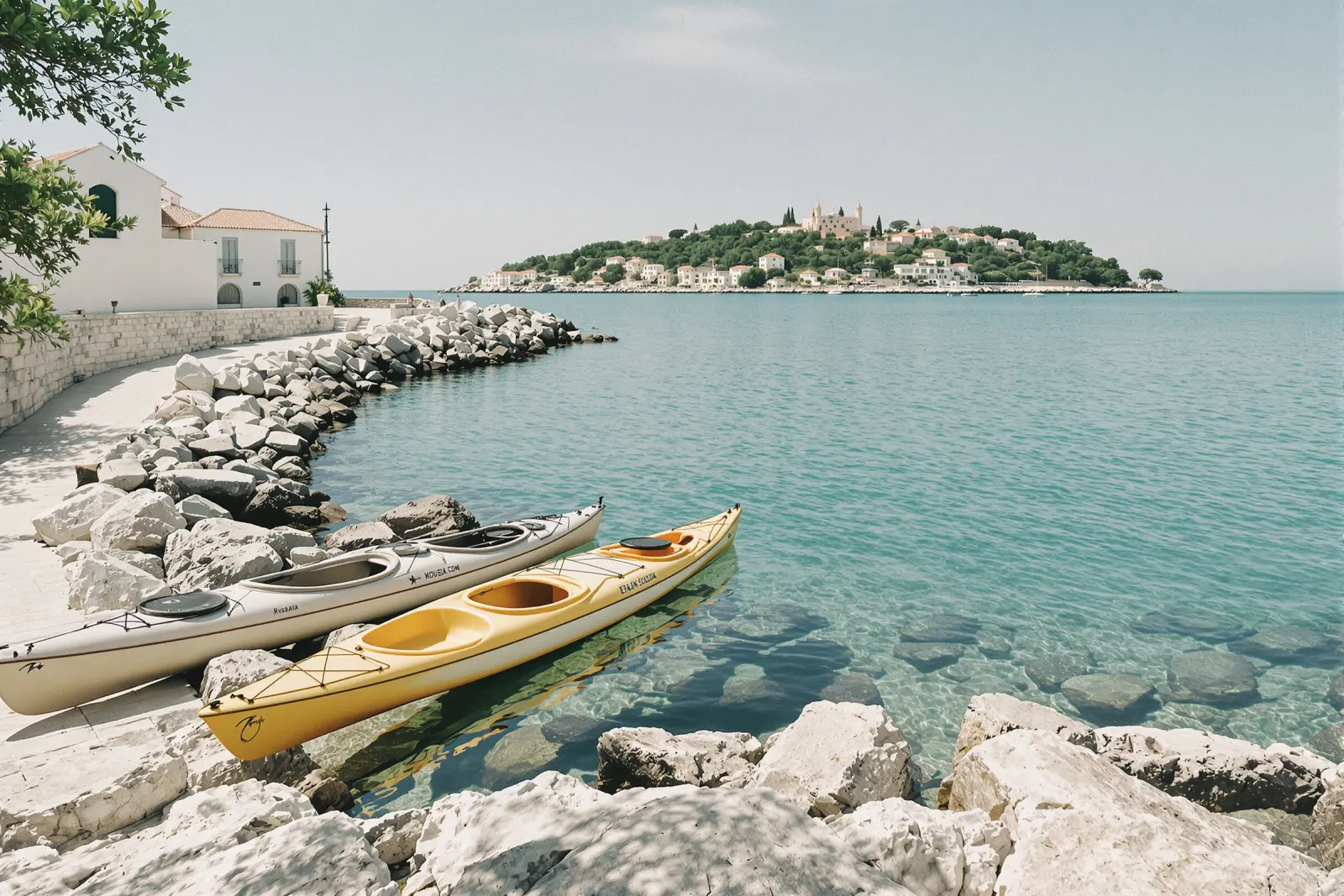 Sea kayaks on the rocks by clear water
