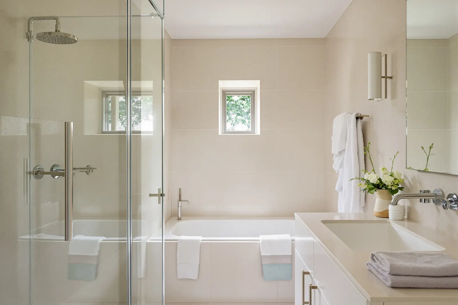 Bathroom with a glass walk-in shower and travertine basin