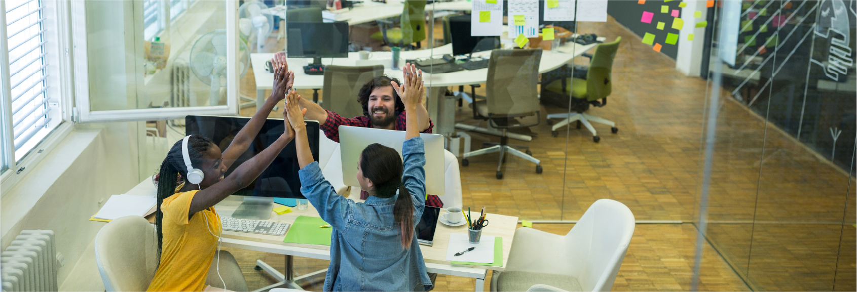 Group of people cheering in aworkplace