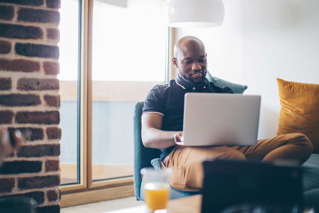 man sitting down at computer