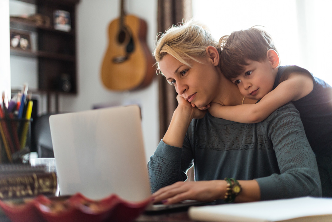 woman on computer with son