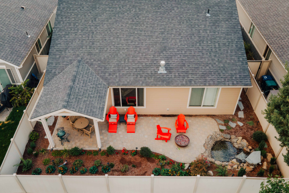 photo of backyard with dining area,  lounging area, fire place, and