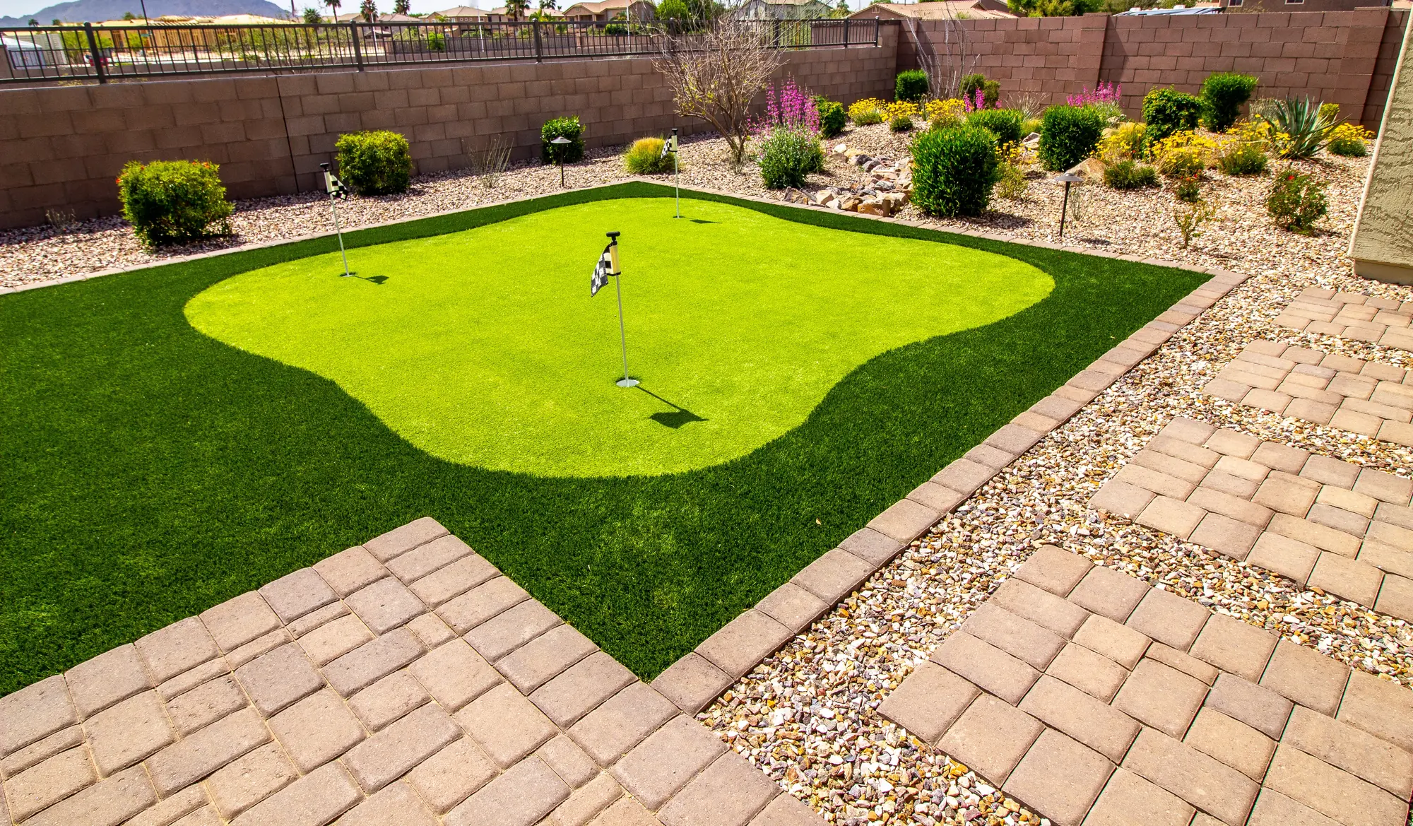 Putting green surrounded by paver pathway — Putting Greens by Cross Creek