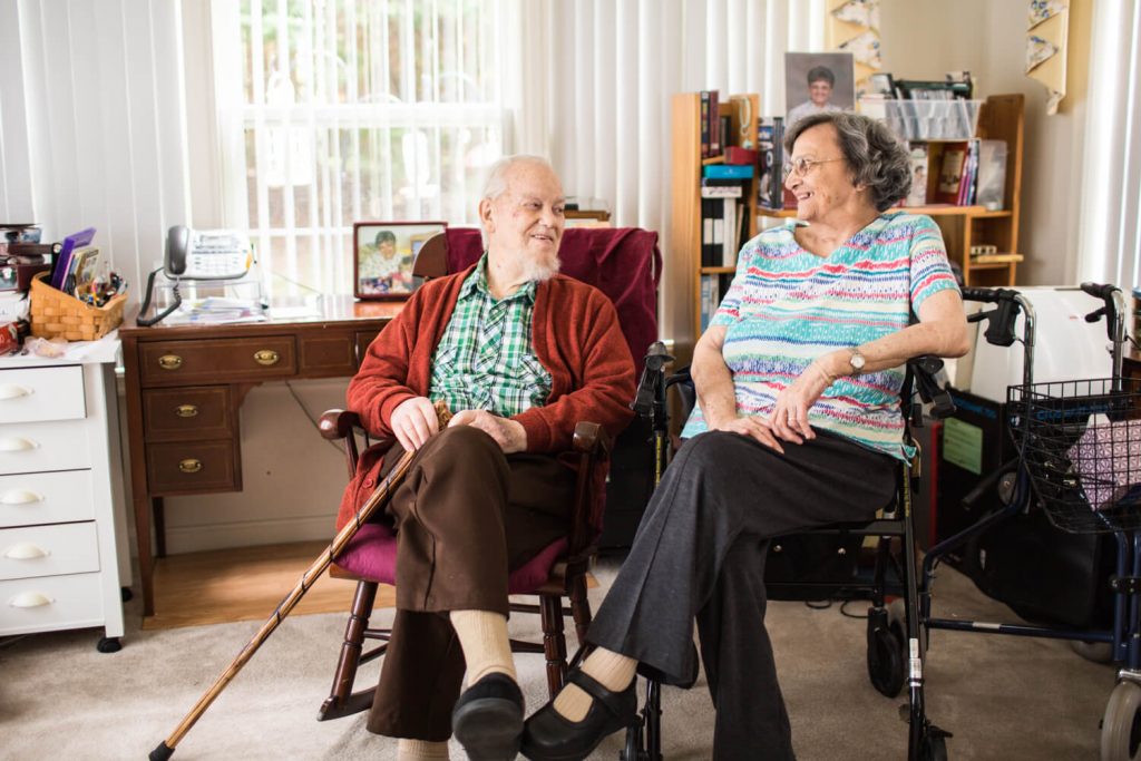 Seniors having a happy conversation through the comfort of their homes because of home care