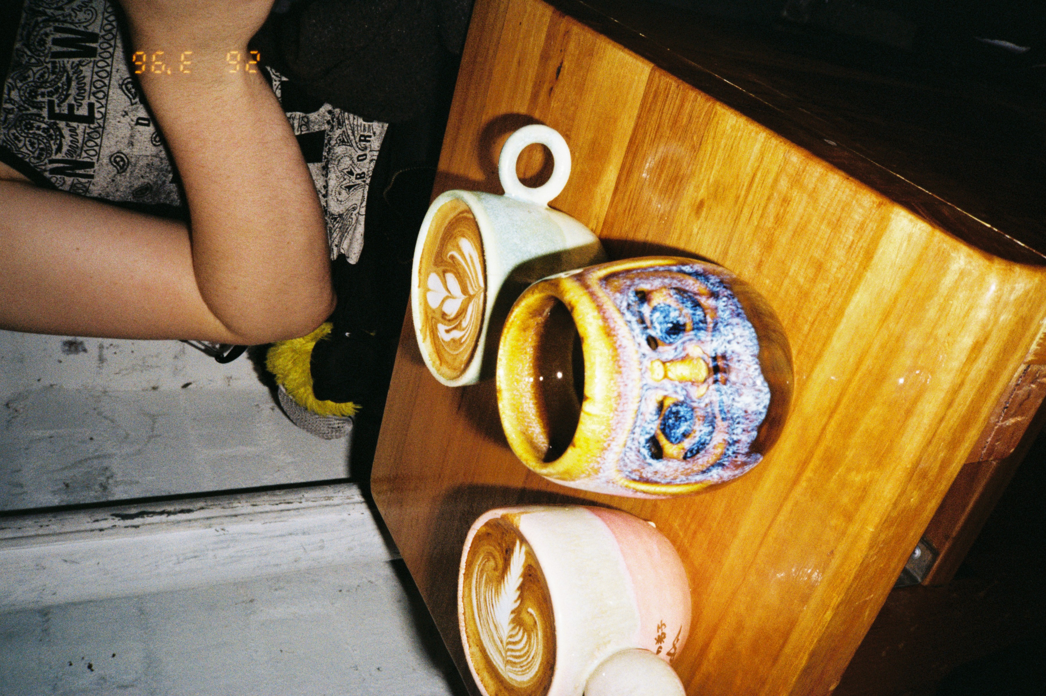 Cups of coffee on a wooden cafe table