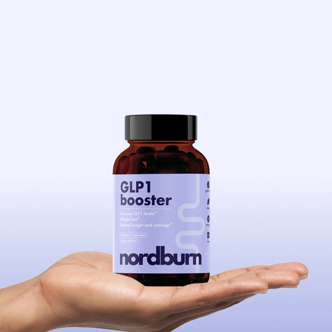A hand holding a bottle of Nordburn GLP-1 Booster