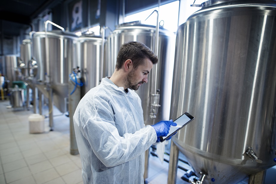 Profissional do setor de alimentos usando tablet para fazer suas anotações