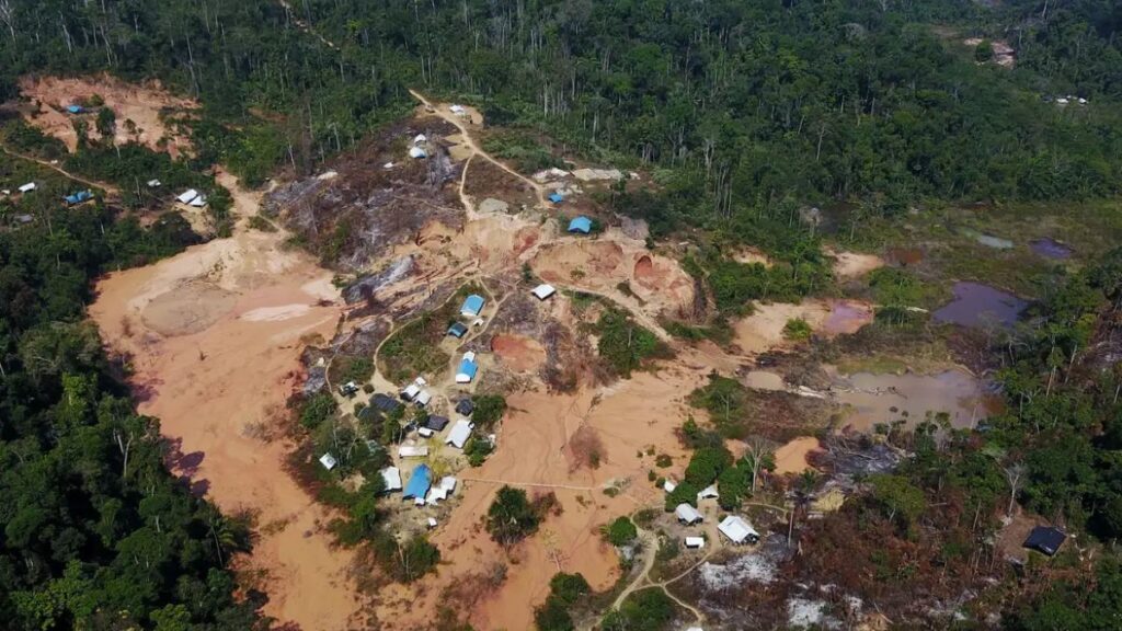 Acampamento de garimpo ilegal na floresta amazônica, mostrando a destruição ambiental e desmatamento