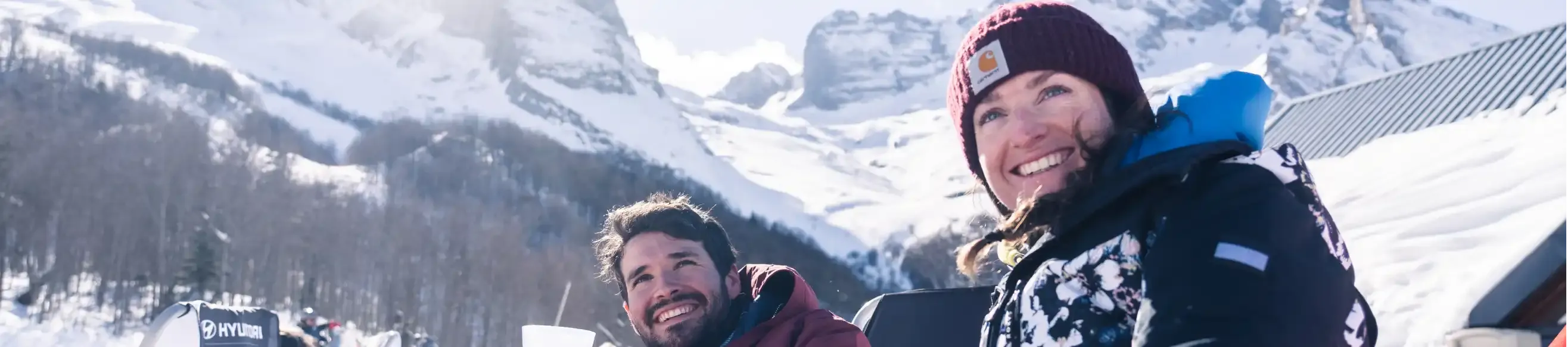 A man and a woman relaxing at a mountain restaurant in Gourette