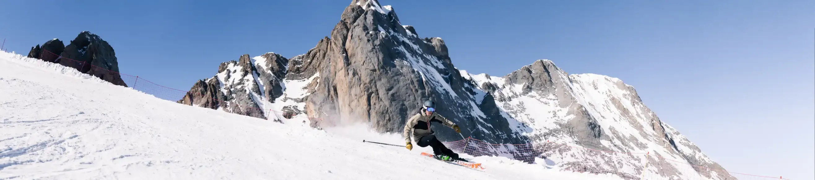 Skier descending a slope under the sun in Gourette