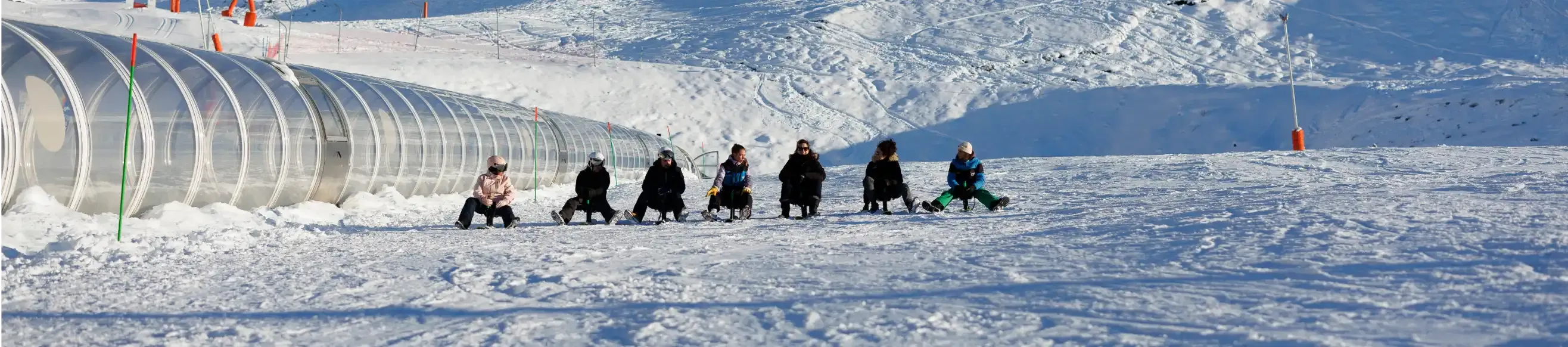 Several people on sleds on the Peyragudes slopes