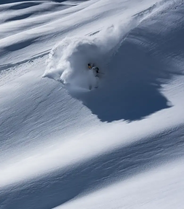 Freeride skier at Pic du Midi de Bigorre, in fresh powder snow.