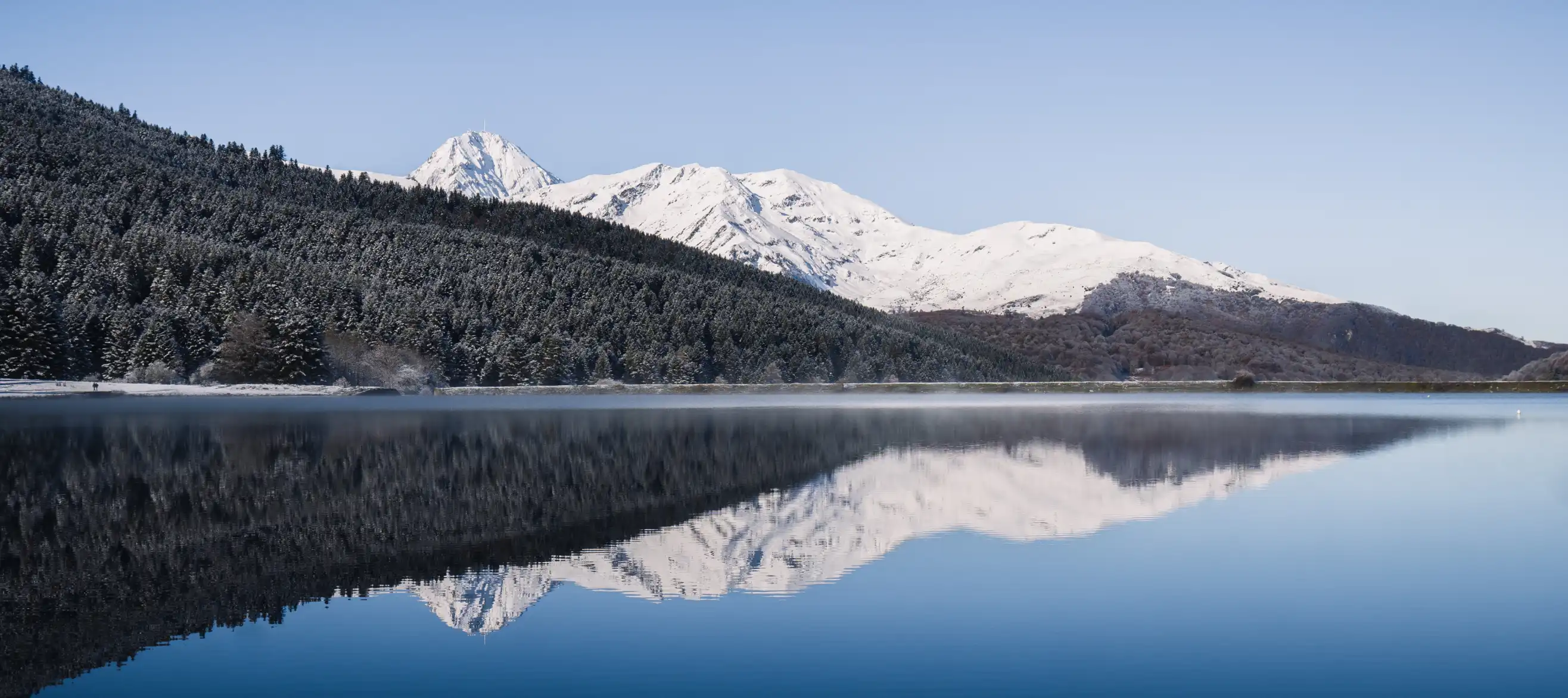 Payolle lake, snow-capped mountains and sun