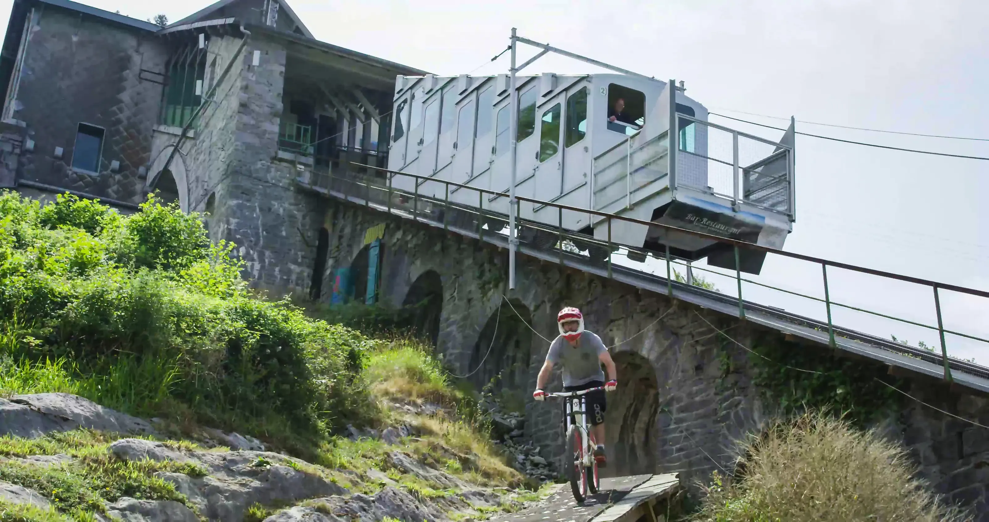 A mountain biker riding down the Pic du Jer