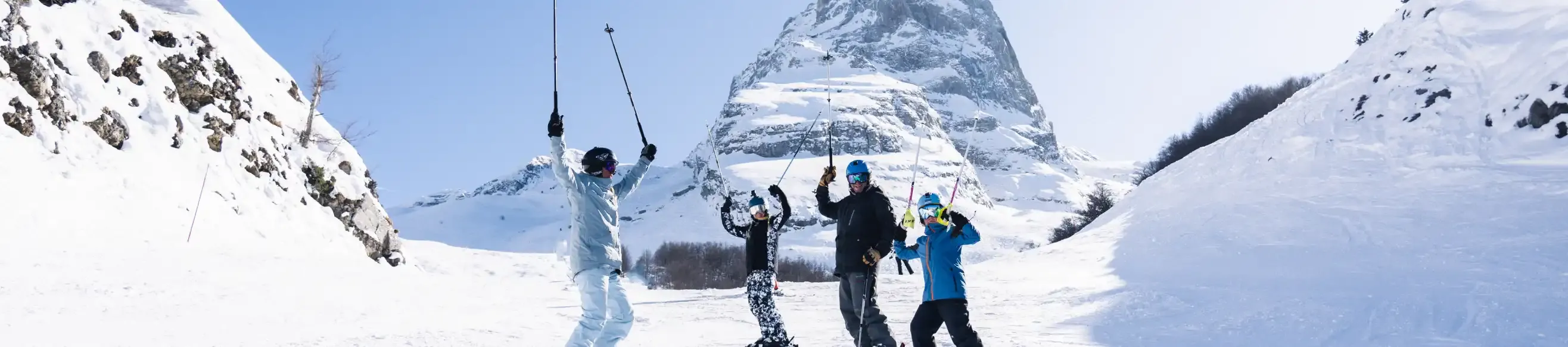 Group of skiers waving on the snowy slopes at Gourette