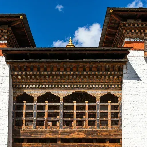 Detailed architecture of a Bhutanese temple with intricate woodwork.