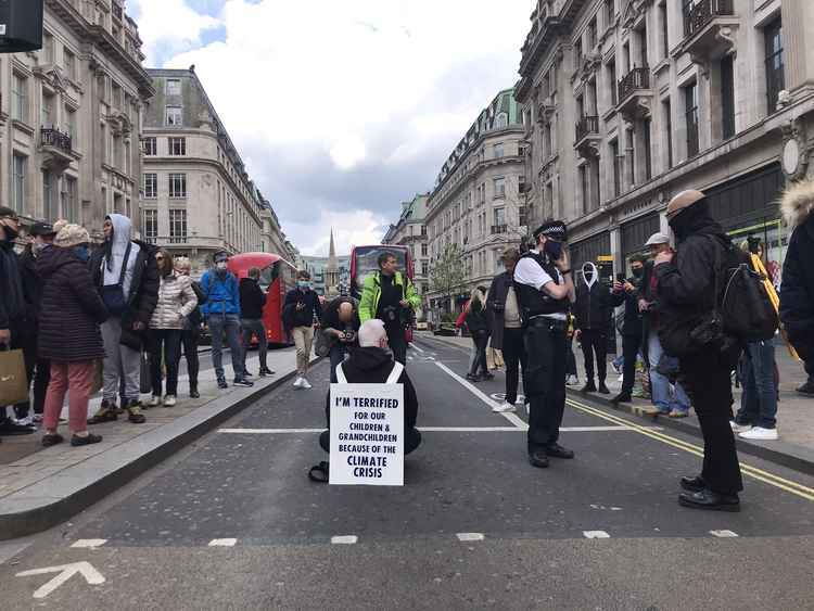 Bernard, 57-year-old Southfields health worker, stopping traffic at Oxford Circus