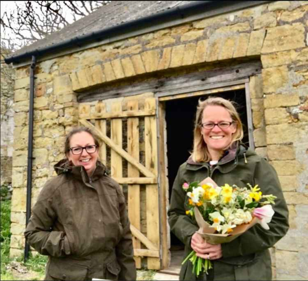 Emma Hughes and Amy Ralph are setting up Abbotsbury Flower Farm