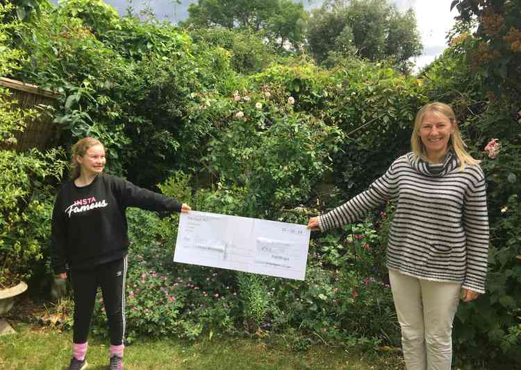 Georgie Cox presenting her donation to Dose of Nature's Dr Alison Greenwood