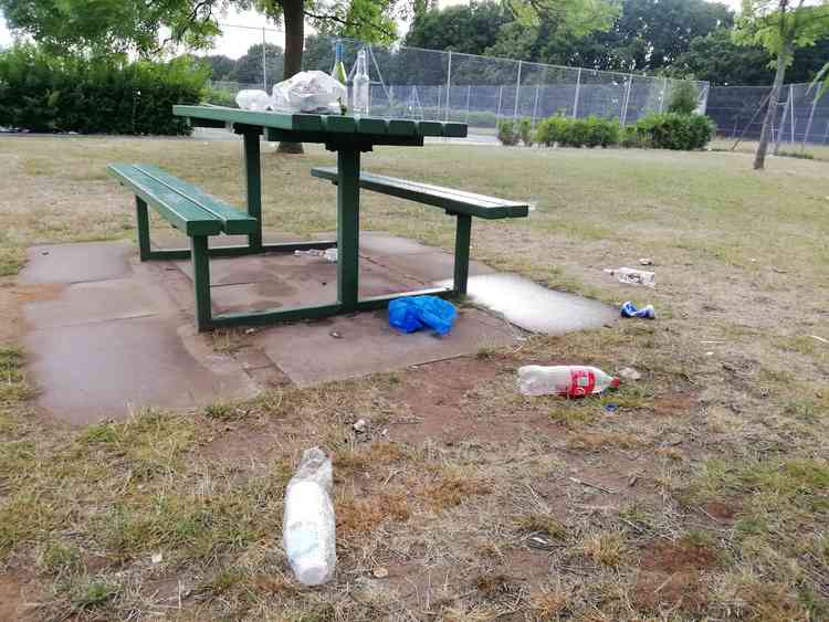 Rubbish left on the benches outside Old Deer Park tennis courts