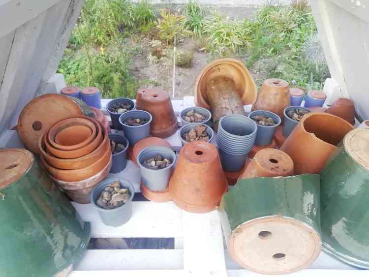 Terracotta pots and tiles under the slate roof