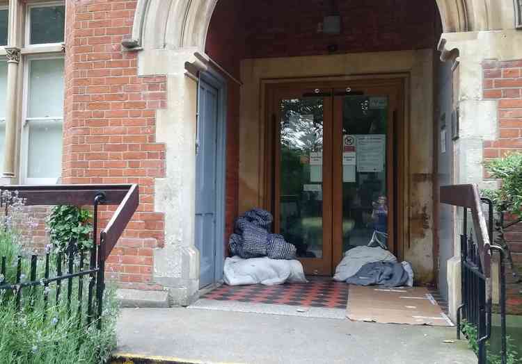 A rough sleeper's belongings in the door to Richmond Lending Library