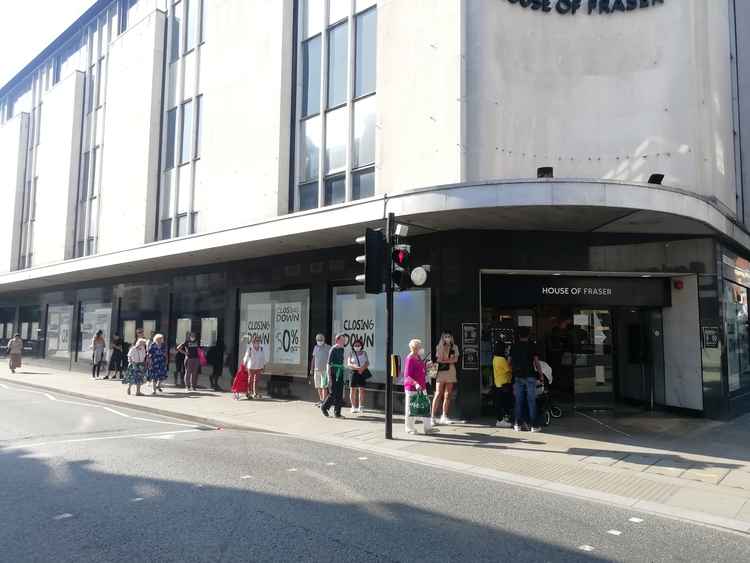 Shoppers queue to get into the department store on Wednesday