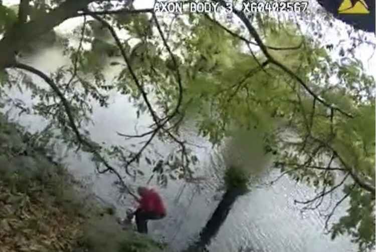Police body cam image of the man going in the water after his dog