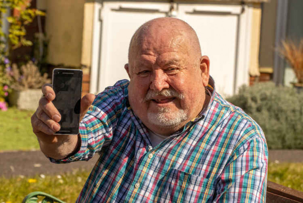 John Phillips with his smartphone