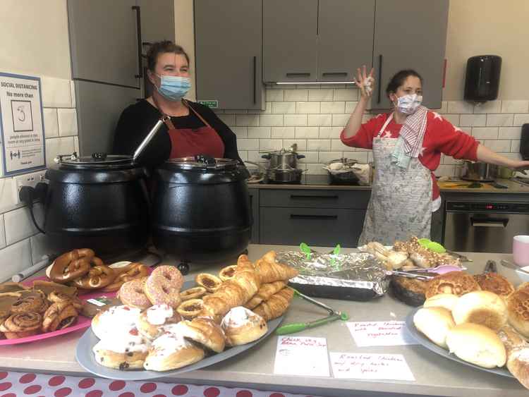 Volunteers Penny and Kenza serve up fresh, wholesome meals