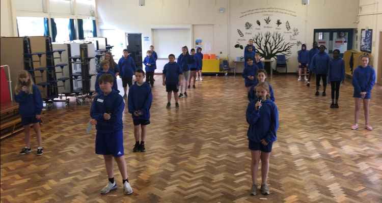 Pupils at St Richard's Primary School posing in socially distanced fashion for their end of year photo